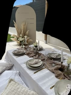 the table is set with plates, silverware and napkins for an elegant dinner