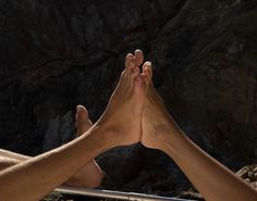 two people are holding their hands together in the air