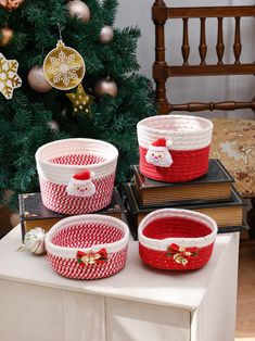 three baskets sitting on top of a table next to a christmas tree