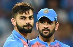 two men in blue shirts and caps standing next to each other with one man's face on his chest