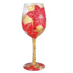 a red and gold wine glass sitting on top of a table