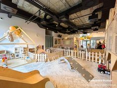 an indoor play area with slides and toys