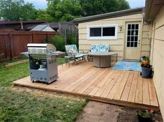 a backyard with a bbq and patio furniture