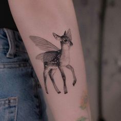 a small deer tattoo on the arm