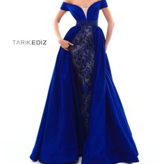 This Tarik Ediz Royal Blue Jeweled Evening Gown With Is Fashioned Off The Shoulder Sleeves V-Neckline And Over Skirt. Worn Once. Not Altered Could Use Dry Clean. A Small Seam Undone Close To The Zipper And On Inner Arm Strap. Not Noticeable When Worn But Easy Fix. Removable Breast Cups, Could Use Dry Clean. Gorgeous! Check Out My Listings For Sherri Hill Macduggal Tony Bowls Rachel Allan Fouad Sarkis Terani And More Luxury Royal Blue Evening Dress With Sweep Train, Luxury Royal Blue Evening Dress For Formal Events, Luxury Blue Gown For Pageant, Glamorous Luxury Royal Blue Dress, Royla Blue And Gold Wedding Dress, Luxury Royal Blue Floor-length Evening Dress, Luxury Royal Blue Dress With Sweetheart Neckline, Luxury Blue Pageant Dress For Wedding, Luxury Blue Evening Dress For Pageant