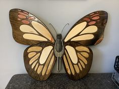 a wooden butterfly sitting on top of a counter