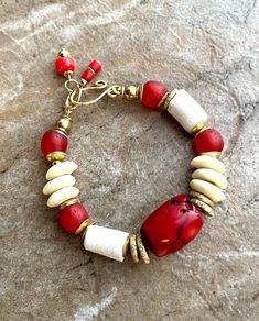 Red Coral Bohemian Bracelet with African Tribal Brass Beads Red Bohemian Jewelry For Beach, Red Bohemian Jewelry For The Beach, Bohemian Red Jewelry For Beach, Red Bohemian Beach Jewelry, Bohemian Red Bracelets With Large Beads, Red Beaded Bracelets For Vacation, Artisan Red Bracelets With Large Beads, Red Bohemian Jewelry For Vacation, Bohemian Red Jewelry For Vacation