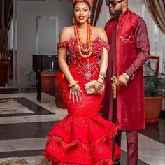 a man and woman dressed in red standing next to each other