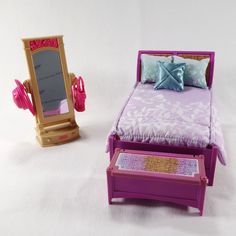 a toy bedroom with a bed, mirror and dressing table