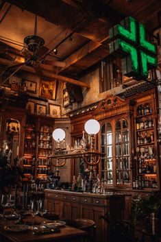 an old fashioned bar with lots of bottles on the shelves and lights hanging from the ceiling