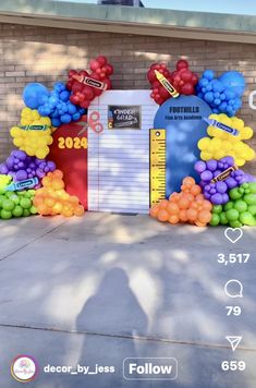 an arch made out of balloons and measuring tape