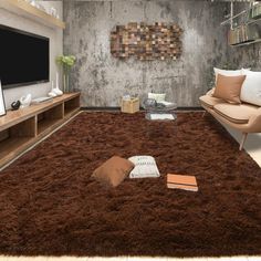 a living room filled with furniture and a flat screen tv on top of a wooden stand