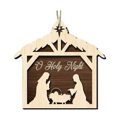 a wooden christmas ornament depicting the birth of jesus