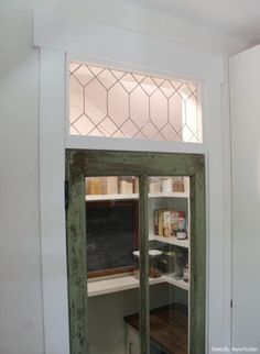 an open pantry door with chalkboard on the wall and shelves in front of it