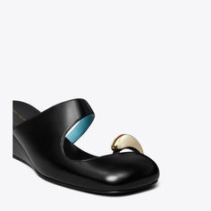 As seen on the Spring '24 runway, our best-selling Pierced collection evolves with a mule wedge, surreal and sculptural. The slip-on shoe features curved edges, negative space and our signature toe ring hardware. A cushioned footbed extends beyond the angular sole, giving the illusion of floating and rounding out the design’s futuristic sensibility.Crafted in partnership with a Leather Working Group-certified tannery, supporting high standards in leather manufacturing and chemical management. Modern Wedge Heels, Modern Evening Wedge Sandals With Sculpted Heel, Modern Evening Wedge Sandals, Modern Slip-on Mules With Heel Loop, Modern Wedge Heel Mules With Heel Loop, Modern Wedge Sandals For Party, Modern Slip-on Heels With Heel Loop, Modern Formal Wedge Sandals With Heel Loop, Modern Formal Mules With Heel Loop