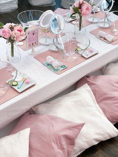 the table is set with pink and white decorations