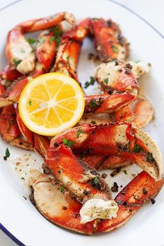 cooked lobsters on a plate with lemon slice