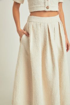 Step out in sartorial sophistication with this Maxi Skirt. Crafted with a timeless tweed fabric, this skirt features subtle pleats that flatter any figure. The waistband and side zipper make it easy to wear while the side pockets keep your essentials close by. Dress up or down this is the perfect piece for any occasion. With the Tweed Maxi skirt, you'll be looking effortless while oozing serious style confidence! Maxi length Pleated Waistband Side zipper Lining Side pockets Hand wash cold Do not Fitted Tweed Pleated Skirt, Tweed Pleated Skirt For Work, Fitted Tweed Skirt With Pockets, Classic Tweed Skirt For Spring, Spring Classic Tweed Skirt, Classic Spring Tweed Skirt, Elegant Tweed Pleated Skirt, Chic Tweed Skirt With Pockets, Elegant Beige Tweed Skirt