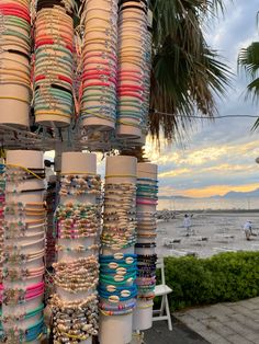 many bracelets and necklaces are on display at the beach