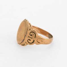 This is part of Chairish’s Fine Jewelry assortment.  Lovely antique Victorian signet ring (circa 1880s to 1900s), crafted in 10 karat rose gold.   The centre oval is inscribed yet due to wear we are unable to decipher the letters.   The side shoulders feature a pretty swirling design that terminates to the oval mount. The saddle of the ring is low and allows the ring to sit flat on the finger.     The ring is in good condition with patina and wear evident. We tend not to clean our antique pieces Victorian Engraved Oval Ring, Victorian Oval Engraved Ring, Vintage Oval 14k Gold Signet Ring, Vintage Oval Signet Ring In 14k Gold, Victorian Oval Engraved Ring For Anniversary, Heirloom Oval Signet Ring, Antique Yellow Gold Signet Ring, Antique Oval Signet Ring Stamped 14k, Antique Oval Hallmarked Signet Ring