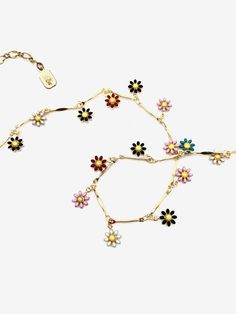 Hummingbird Enameled Flower Choker Similar to our best-selling enameled fringe chokers, this rainbow enameled adjustable necklace features a rainbow of flowers that dangle around your neck! Detailed Description: Material: Gold plated brass, enamel Dimensions: Adjustable 13-16" Craftsmanship: Hand-assembled Perfect For: A pop of bright color Layering Those who aren't afraid to be bold with their jewelry. Why You'll Love It: This necklace is guaranteed to bring you happiness Wrap twice to wear as Adjustable Multicolor Flower Necklace With Flower Charm, Bohemian Multicolor Flower Necklace, Enamel Flower Charm Necklace, Whimsical Multicolor Flower Necklace, Knife Necklace, Multicolor Flower-shaped Jewelry With Charms, Hummingbird Flowers, Flower Choker, Enamel Flower