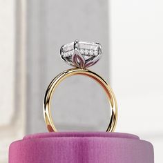 a close up of a ring on top of a pink ribbon