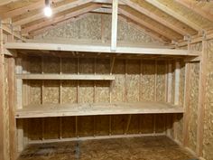 an unfinished room with wooden shelves and plywood