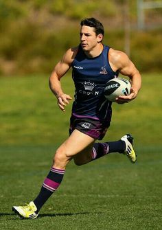 a man running with a rugby ball in his hand