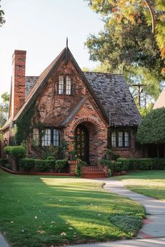 a brick house with green grass and trees