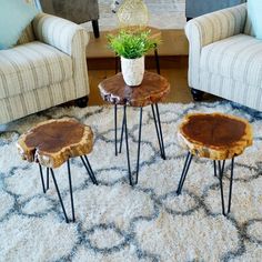 three wooden tables sitting on top of a rug in a living room next to couches