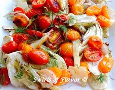 a white plate topped with lots of veggies and tomatos on top of it