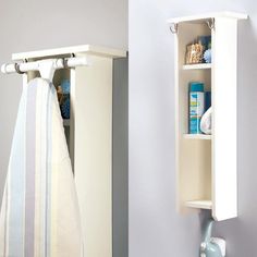 a towel rack is hanging on the wall next to a white cabinet with towels in it