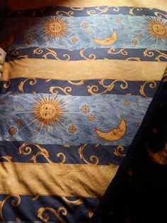 the sun and moon are depicted on this comforter