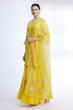 Yellow kurta with floral embroidered motifs and stripes detail. Paired with sharara and sheer dupatta.
Components: 3
Fabric: Pure Silk Chanderi, Chiffon, Organza
Neckline: V neck
Sleeve Length: Three quarter
Color: Yellow
Embroidered
Floral motif work
Sheer dupatta
Tiered sharara
Bead and pearl work
Flared sleeves - Aza Fashions Yellow Kurta, Pearl Work, Kurta Set For Women, Fashion App, Kurta Set, Set For Women, Flared Sleeves, Aza Fashion, Pure Silk