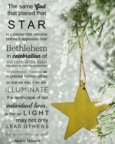 a christmas ornament hanging from a tree with the words, and an image of a