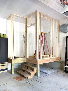 an unfinished room with stairs and tools on the floor