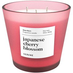 the japanese cherry blossom scented candle is pink and has a label on it that says,