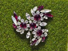 Elevate your style with this stunning large red and clear rhinestone statement brooch. Designed to make a bold impression, this brooch features a dazzling array of vibrant red and sparkling clear rhinestones set in a striking design. Perfect for adding a touch of glamour to any outfit, this piece is a true showstopper! **Key Features - **Material High-quality rhinestones with metal setting - **Design Large statement brooch featuring red and clear rhinestones in an intricate pattern - **Condition Excellent pre-owned condition - **Closure Secure pin back This eye-catching brooch is ideal for special occasions, formal events, or simply adding a splash of sparkle to your everyday look. Its dramatic design ensures it will be a focal point of any outfit. **Why You'll Love It - **Dazzling Design Vintage Red Brooches For Party, Red Rhinestone Brooch For Gift, Red Rhinestone Brooches For Gifts, Formal Red Rhinestone Brooch, Vintage Red Jewelry With Rhinestones, Vintage Pins, Visual Effects, Clear Rhinestones, Vibrant Red