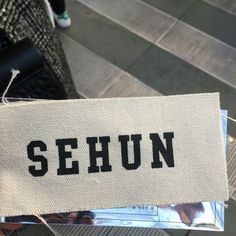 the name sehun is written on a piece of fabric that has been pinned to it