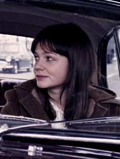 a woman sitting in the back seat of a car