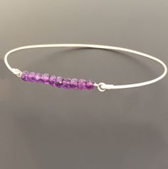 "Amethyst Bead Bracelet - Amethyst Bracelet - February Birthstone Jewelry - A row of 10 faceted amethyst gemstone beads has been transformed into an elegant amethyst beaded bangle bracelet with your choice of sterling silver or 14k gold filled bangle band. Perfect for a February birthstone bracelet. This February amethyst jewelry can be personalized with an initial dangle. Simply add to cart to make a customized amethyst beaded bracelet; http://www.etsy.com/listing/84670605/add-an-initial-charm- Adjustable Faceted Amethyst Jewelry, Purple Beaded Birthstone Bracelets As Gift, Purple Beaded Birthstone Bracelets For Gift, Purple Birthstone Beaded Bracelets As Gift, Purple Birthstone Beaded Bracelets For Gift, Adjustable Lavender Birthstone Jewelry, Purple Beaded Bracelets For Birthday, Purple Beaded Bracelet For Birthday, Spiritual Amethyst Beaded Birthstone Bracelet