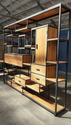 an industrial storage unit with shelves and drawers in the middle of a warehouse flooring area