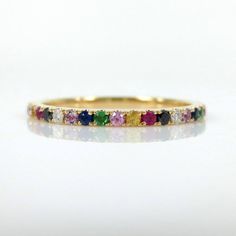 This gorgeous Eternity Band is available in your choice of 18K White, Yellow, and Rose Gold.  It features 0.55 carats of pavé set multi-colored brilliant diamonds and gemstones all the way around creating a repeating rainbow effect. The Rainbow eternity band is the perfect complement to any engagement ring or as stackable bands. Total carat weight: 0.55cts Based on ring size: 6.5 •Diamonds•Black Diamonds•Blue Sapphires•Pink Sapphires•Yellow Sapphires•Ruby•Amethyst•Tsavorites ( Green Garnets) *** Multicolor 14k Gold Jewelry For Wedding, Multicolor Brilliant Cut Jewelry For Weddings, Rainbow Cubic Zirconia Jewelry For Wedding, Rainbow Cubic Zirconia Wedding Jewelry, Multicolor Round Band Wedding Jewelry, Rainbow Multi-stone Wedding Jewelry, Rainbow Multi-stone Jewelry For Wedding, Multicolor Halo Jewelry For Wedding, Pave Wedding Bands