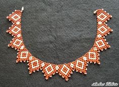 an orange and white beaded necklace on a black surface with the words,'beads are