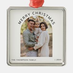 a christmas ornament with an image of a couple and their child on it