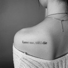 the back of a woman's shoulder that says love me till die