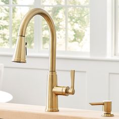 a kitchen faucet that is gold in color