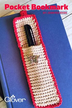 a crocheted pocket bookmark with a pen in it