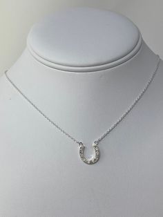 Minimalist Sterling Silver Simulated Diamonds Set Horse Shoe Necklace. Lucky Horse Shoe Charm Necklace With CZ Diamonds. Minimalist Chain With Extension Sterling Silver Horse Shoe Necklace ------------------------------------- Pendant Length: L- 1/2 INCH Pendant Width: W- 1/2 INCH Weight:3.2 gram Nickel and Lead Free:YES ------------------------------------- You will receive the item in a gift pouch. This is a beautiful necklace, sure to make you feel special. Treat yourself or give as a gift! P Silver Horseshoe Necklace For Gift, Horseshoe Necklace With Adjustable Chain For Gift, Horseshoe Necklace With Adjustable Chain As Gift, Sterling Silver Horseshoe Necklace For Gifts, Horseshoe-shaped Jewelry With Adjustable Chain For Gifts, Horseshoe Jewelry With Adjustable Chain For Gifts, Elegant Silver Horseshoe Necklace, Elegant Horseshoe Necklace For Everyday, Horse Shoe Necklace