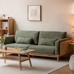 a living room with a couch, coffee table and bookshelf on the wall